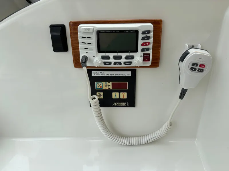 Slide: The Image of Control panel of a 2006 MJM 34z Express HT boat with radio and microphone. - 22