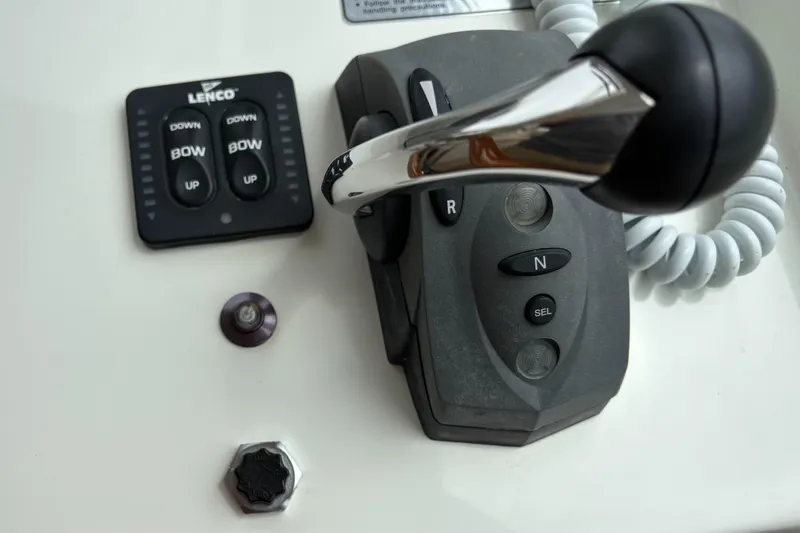 Slide: The Image of Control panel of 2006 MJM 34z Express HT boat with throttle and trim tab switches. - 24