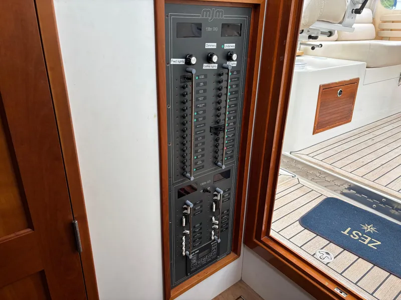 Slide: The Image of Electrical panel inside a 2006 MJM 34z Express HT boat, near wooden door and deck. - 28