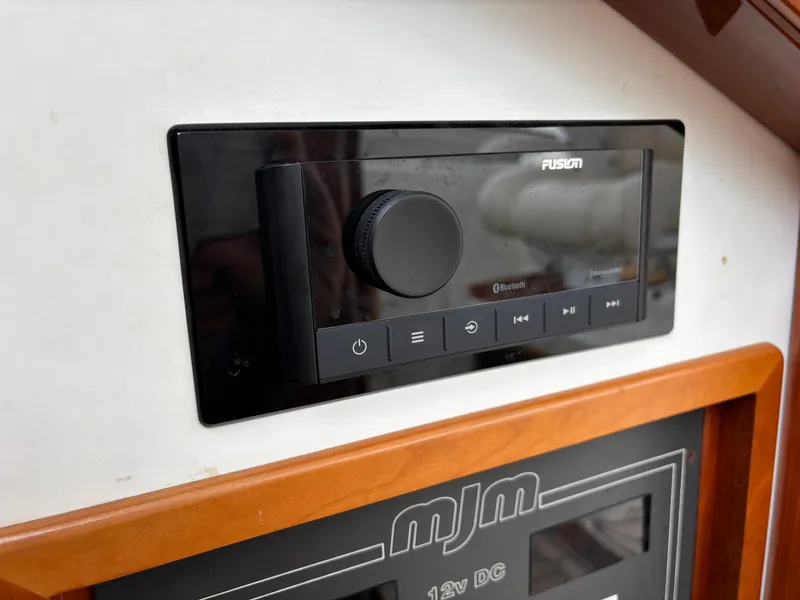 Slide: The Image of Control panel of a 2006 MJM 34z Express HT boat with Fusion audio system. - 29