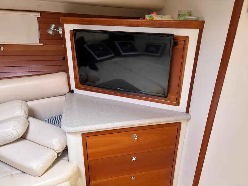 Slide: The Image of Interior of 2006 MJM 34z Express HT with TV, wooden cabinetry, and cream seating. - 33
