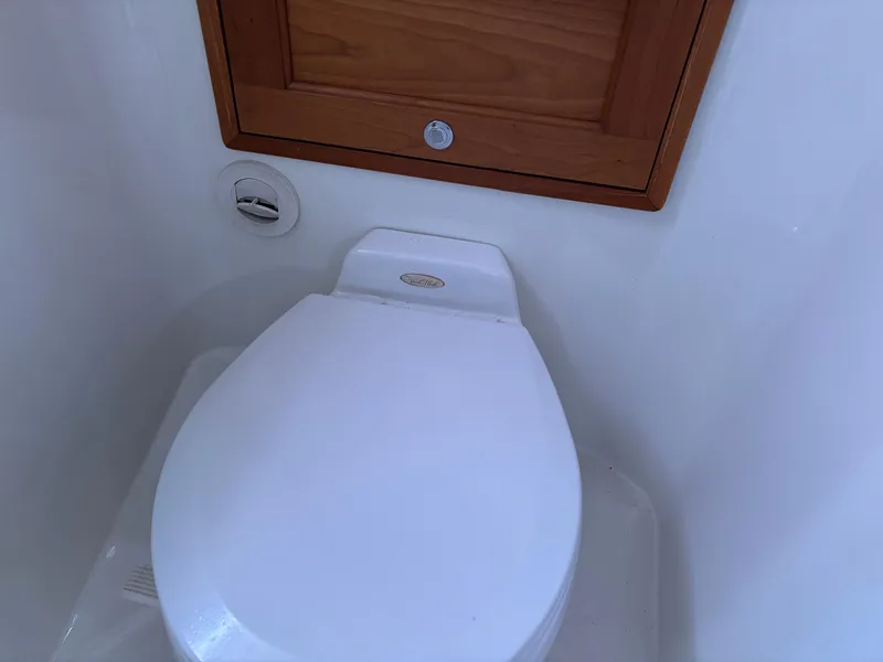 Slide: The Image of Toilet in 2006 MJM 34z Express HT boat bathroom, featuring wooden cabinet. - 35