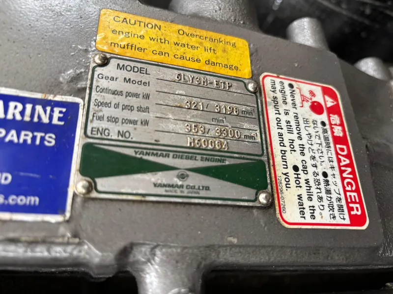 Slide: The Image of Yanmar diesel engine plate with caution and danger labels on MJM 34z Express HT, 2006 model. - 37