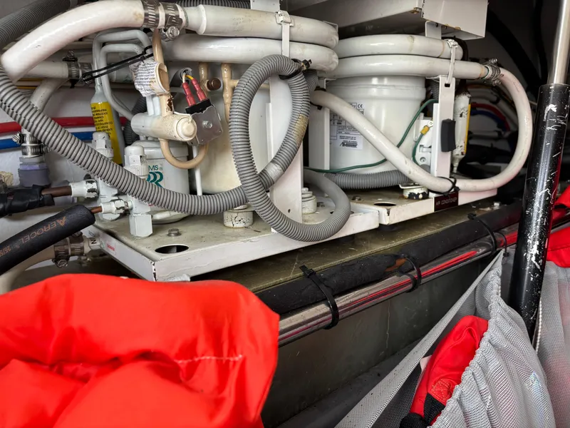 Slide: The Image of Engine compartment of a 2006 MJM 34z Express HT with visible mechanical components and wiring. - 38