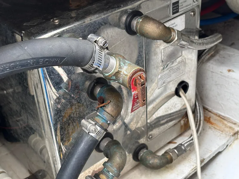 Slide: The Image of Engine compartment of a 2006 MJM 34z Express HT with hoses and metal fittings. - 39