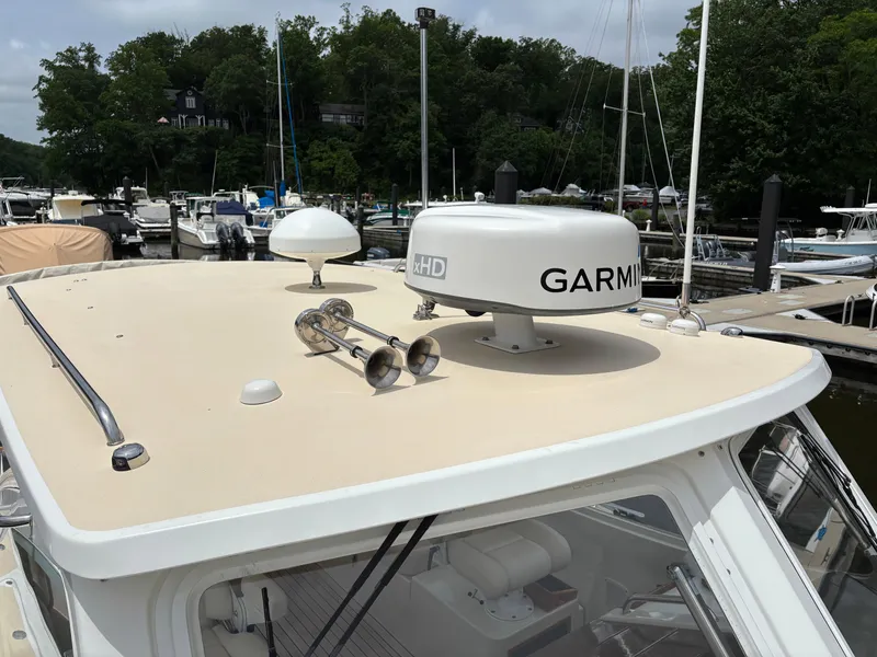 Slide: The Image of 2006 MJM 34z Express HT boat with Garmin radar, docked in a marina. - 43