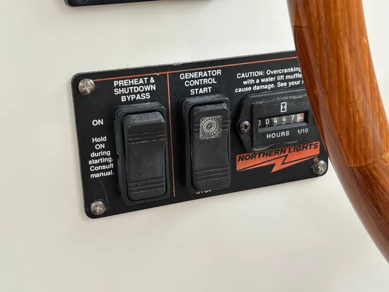 Slide: The Image of Control panel of a 2006 MJM 34z Express HT boat with generator switches. - 46