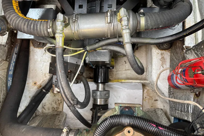 Slide: The Image of Engine compartment of a 2006 MJM 34z Express HT with visible hoses and components. - 50