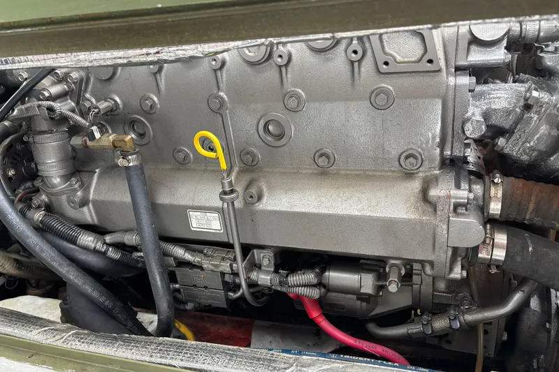 Slide: The Image of Engine of 2006 MJM 34z Express HT boat, showcasing mechanical components and wiring. - 52