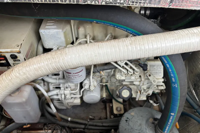 Slide: The Image of Engine compartment of a 2006 MJM 34z Express HT with visible hoses and components. - 53