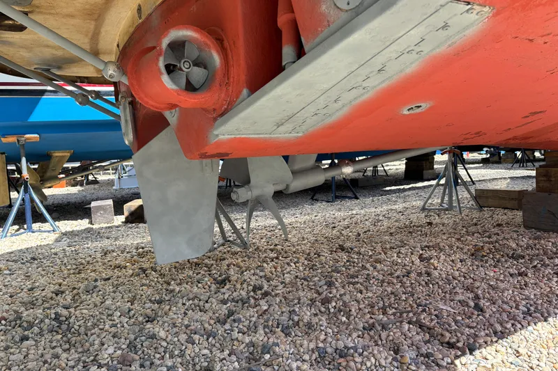 Slide: The Image of Underneath view of a 2006 MJM 34z Express HT boat on gravel. - 55