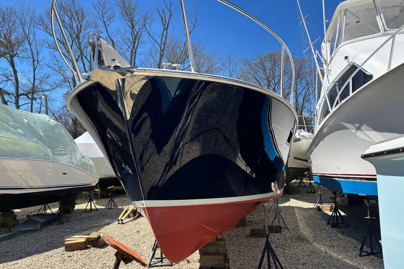 Slide: The Image of 2006 MJM 34z Express HT boat on stands, surrounded by other vessels. - 7