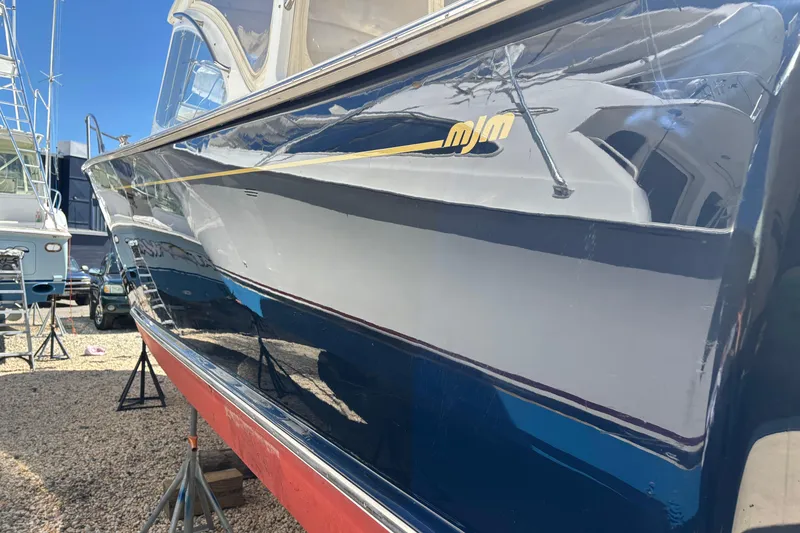 Slide: The Image of 2006 MJM 34z Express HT boat on stands, reflecting sunlight. - 8