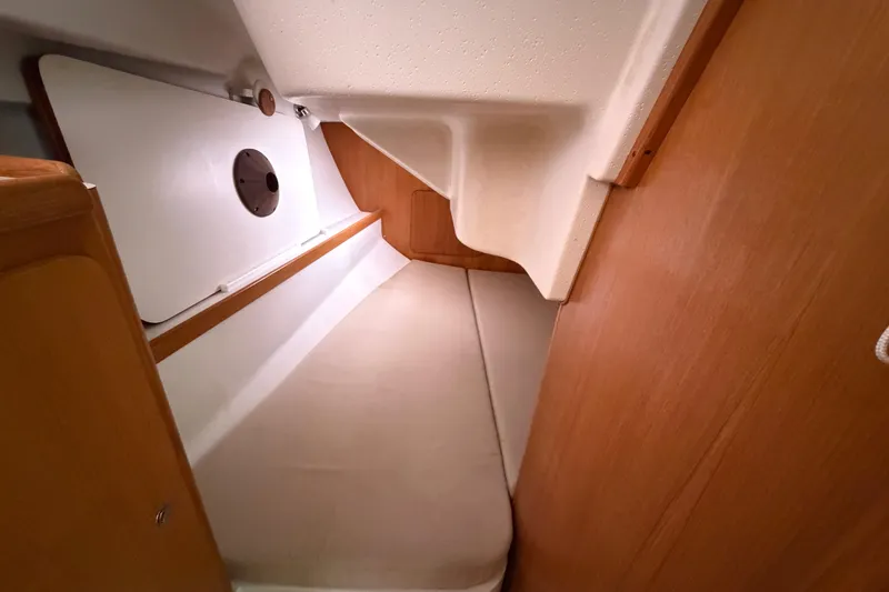 Slide: The Image of Interior cabin of a 2007 Catalina 309 sailboat, featuring a cozy sleeping area. - 12