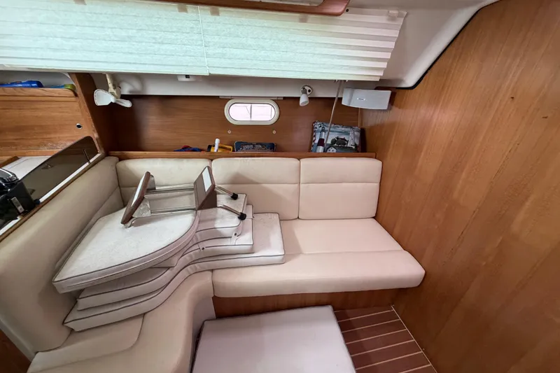 Slide: The Image of Interior of a 2007 Catalina 309 sailboat with beige seating and wooden accents. - 13