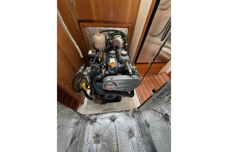 Slide: The Image of Engine compartment of a 2007 Catalina 309 sailboat, showcasing detailed mechanical components. - 14