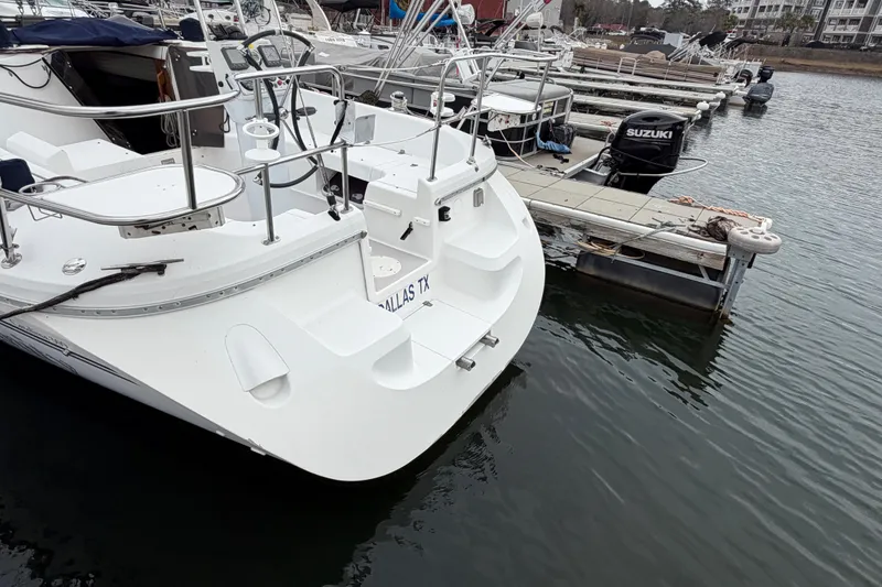 Slide: The Image of Catalina 309 sailboat docked at marina, showcasing sleek design and spacious deck, 2007 model. - 22