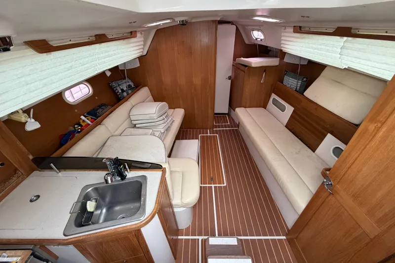 Slide: The Image of Interior of 2007 Catalina 309 sailboat with wood finish and cozy seating. - 27