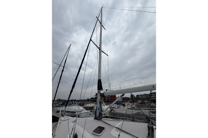 Slide: The Image of Sailboat mast of a 2007 Catalina 309 under cloudy skies at a marina. - 5