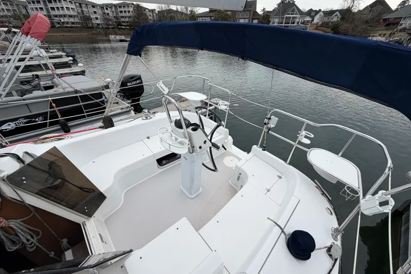Slide: The Image of 2007 Catalina 309 sailboat cockpit with steering wheel, docked in a marina. - 6