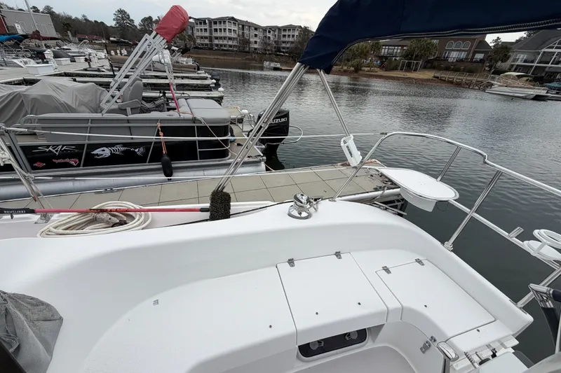 Slide: The Image of Catalina 309 sailboat docked at marina, showcasing deck and surrounding boats, 2007 model. - 8
