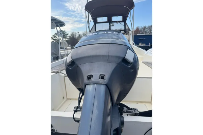 Slide: The Image of 1987 Mako 230 Walk Around boat with outboard motor, viewed from the stern. - 19