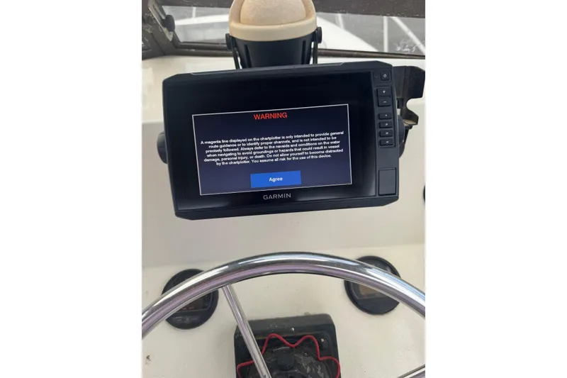 Slide: The Image of Garmin navigation display with warning message on 1987 Mako 230 Walk Around boat. - 5