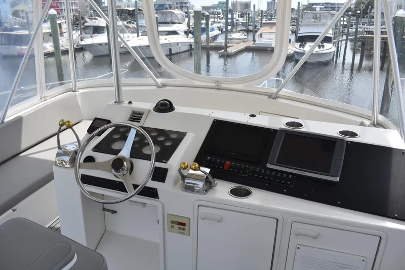 Slide: The Image of Cockpit of 1998 Ocean Yachts 40 Super Sport with steering wheel and navigation equipment. - 11