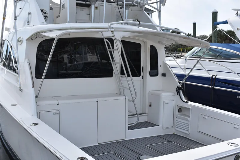 Slide: The Image of 1998 Ocean Yachts 40 Super Sport, sleek white exterior, docked at marina. - 18