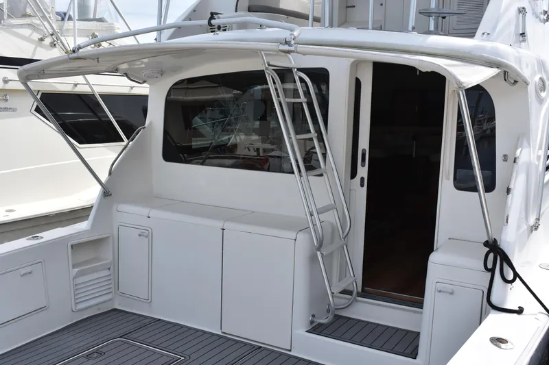 Slide: The Image of 1998 Ocean Yachts 40 Super Sport boat with sleek white exterior and ladder access. - 21