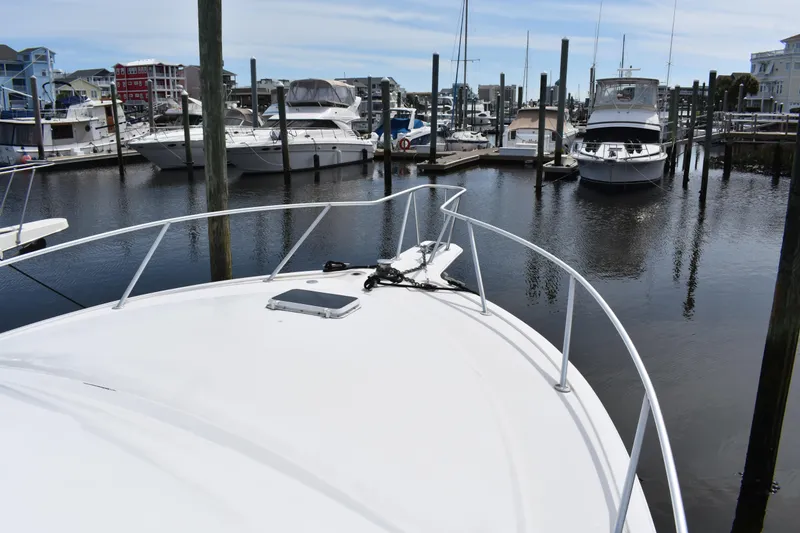 Slide: The Image of 1998 Ocean Yachts 40 Super Sport docked in a marina with other boats. - 23