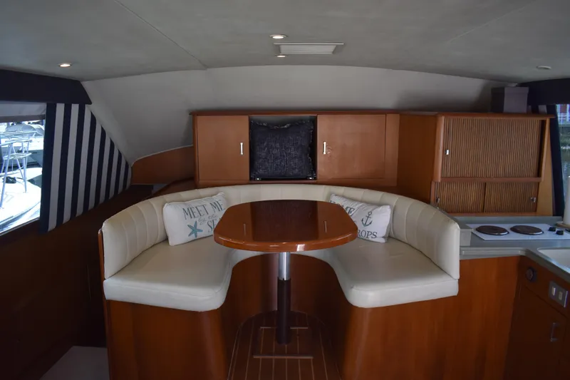 Slide: The Image of Interior of 1998 Ocean Yachts 40 Super Sport with cozy seating and wooden cabinetry. - 25