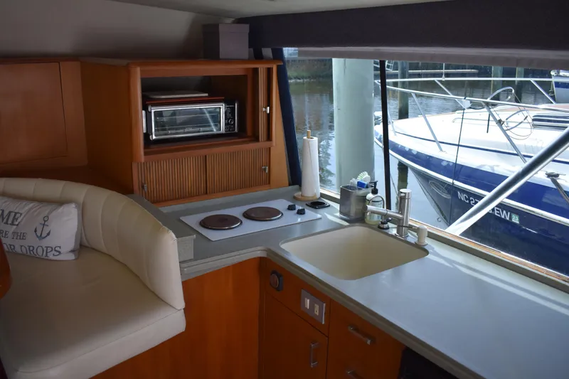 Slide: The Image of Interior of 1998 Ocean Yachts 40 Super Sport with kitchenette and marina view. - 27