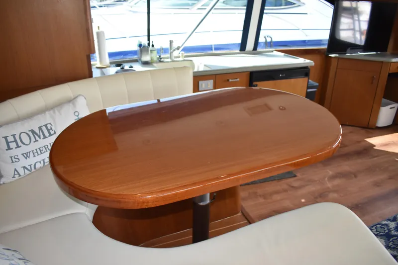 Slide: The Image of Interior of 1998 Ocean Yachts 40 Super Sport with wooden table and white seating. - 29