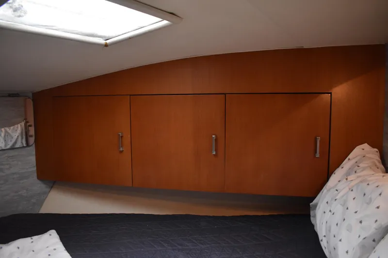 Slide: The Image of 1998 Ocean Yachts 40 Super Sport cabin with wooden cabinets and bed. - 32