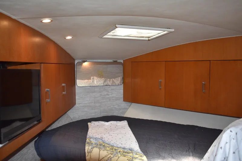 Slide: The Image of Interior cabin of 1998 Ocean Yachts 40 Super Sport with wood cabinets and cozy bedding. - 33