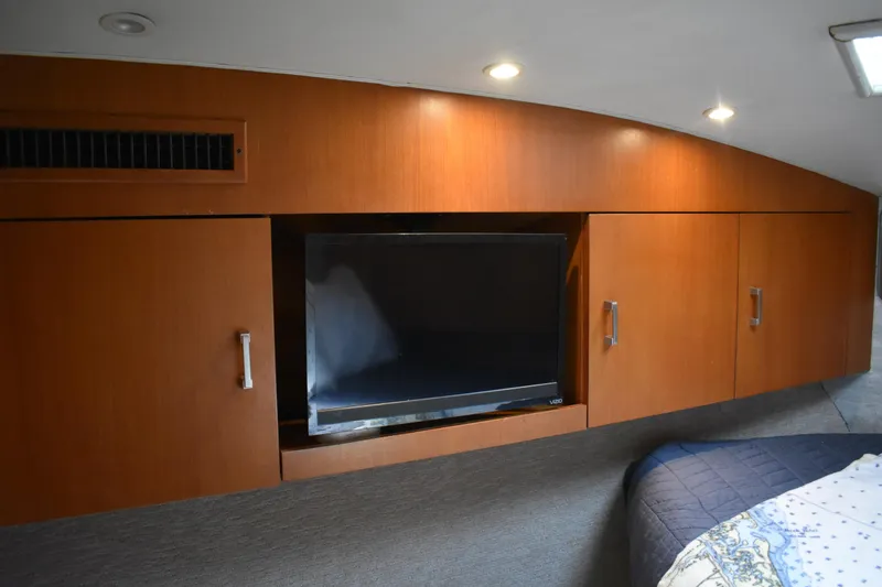 Slide: The Image of Interior of 1998 Ocean Yachts 40 Super Sport with TV and wooden cabinetry. - 34