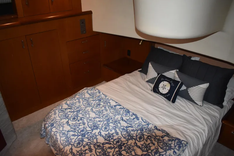 Slide: The Image of Cozy bedroom in 1998 Ocean Yachts 40 Super Sport with nautical-themed bedding. - 35