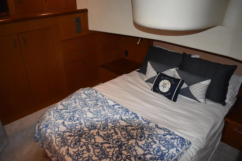 Slide: The Image of Cozy bedroom in 1998 Ocean Yachts 40 Super Sport with nautical-themed bedding. - 36