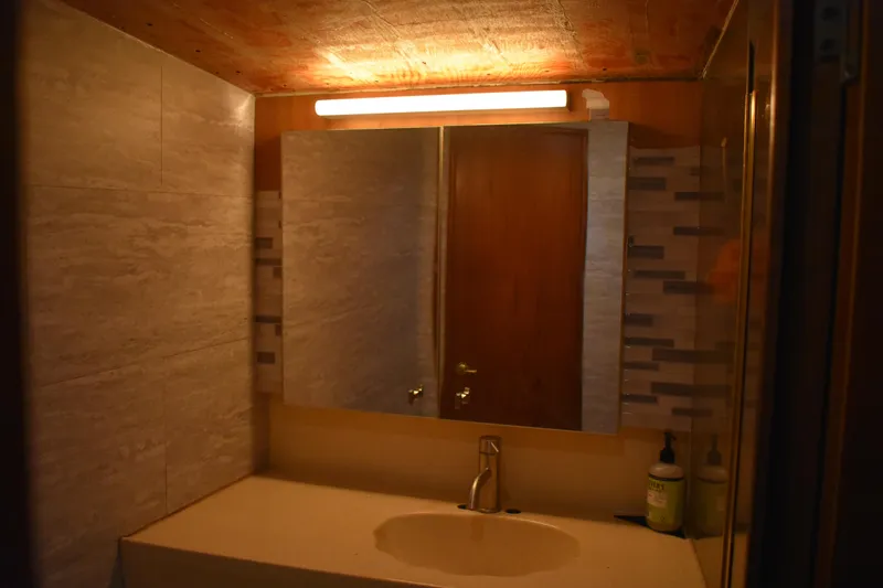 Slide: The Image of Bathroom vanity with mirror and lighting in 1998 Ocean Yachts 40 Super Sport. - 38