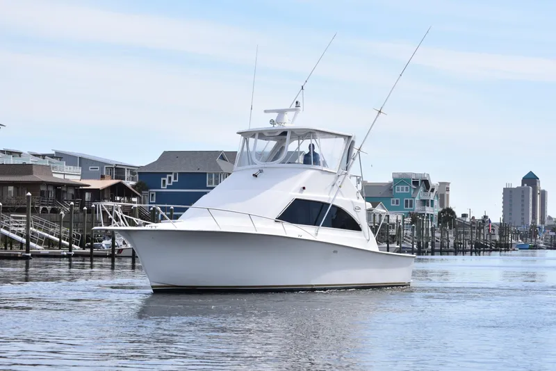 Slide: The Image of 1998 Ocean Yachts 40 Super Sport cruising near waterfront homes. - 5