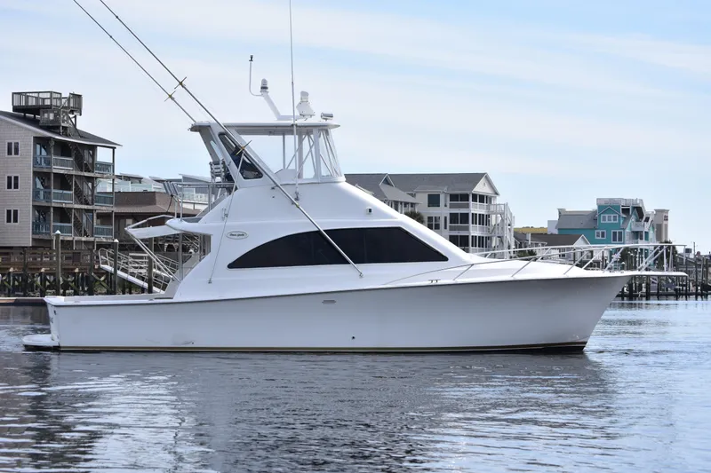 Slide: The Image of 1998 Ocean Yachts 40 Super Sport yacht docked near waterfront buildings. - 8