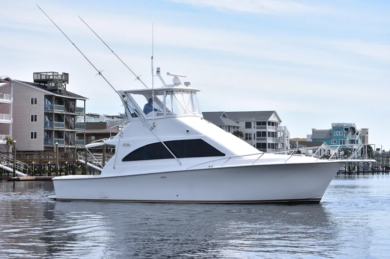 Slide: The Image of 1998 Ocean Yachts 40 Super Sport cruising near waterfront homes. - 9