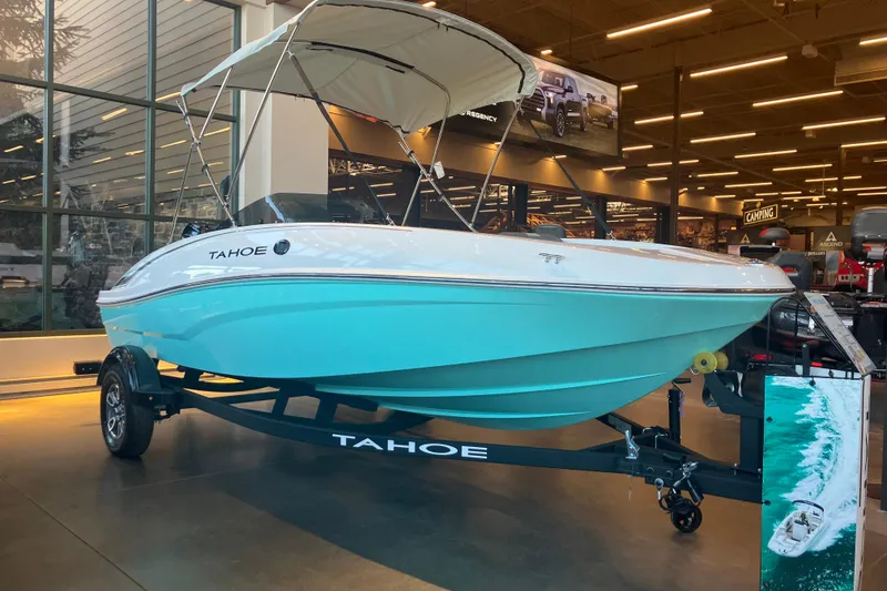 The Image of 2026 Tahoe T16 boat displayed indoors with canopy and trailer. - 0