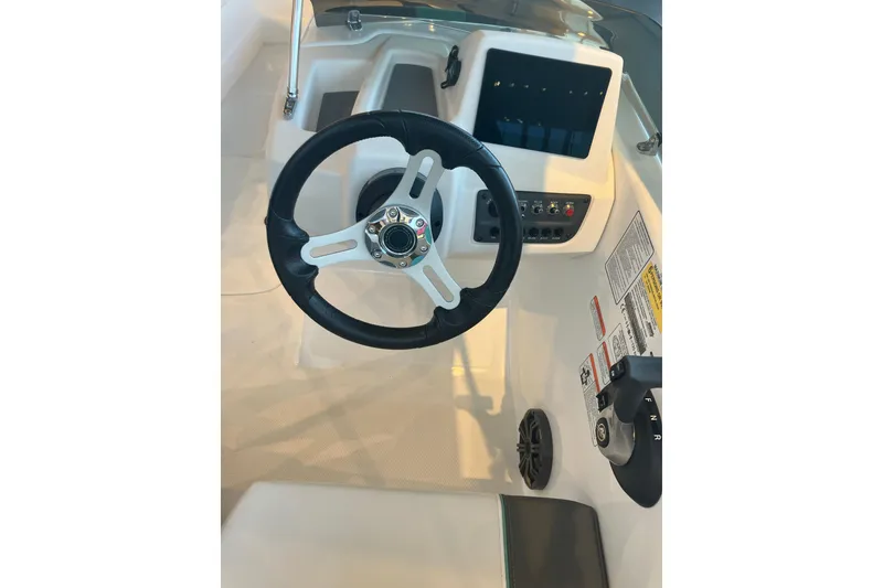 Slide: The Image of Steering wheel and dashboard of 2026 Tahoe T16 boat, featuring modern controls and design. - 8