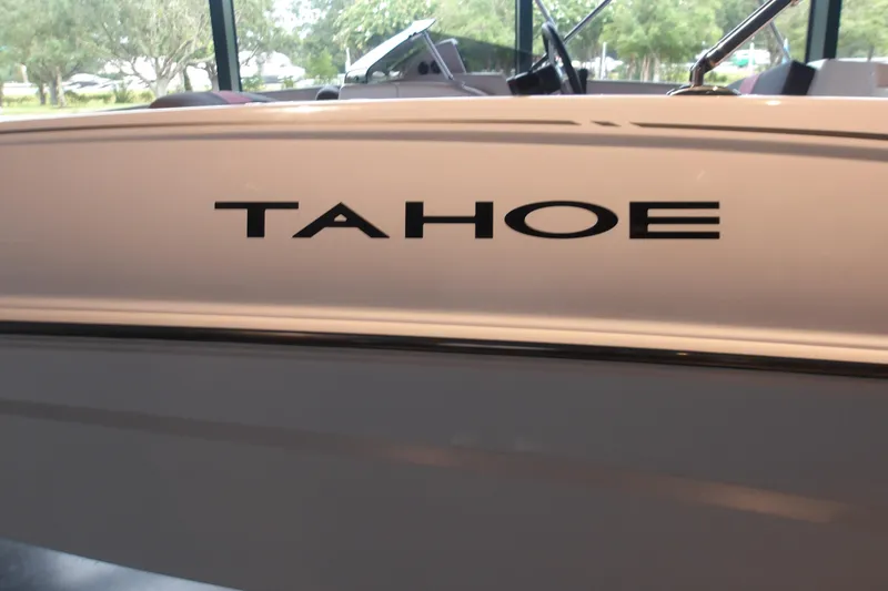 Slide: The Image of 2026 Tahoe T16 boat side view with logo in showroom setting. - 11