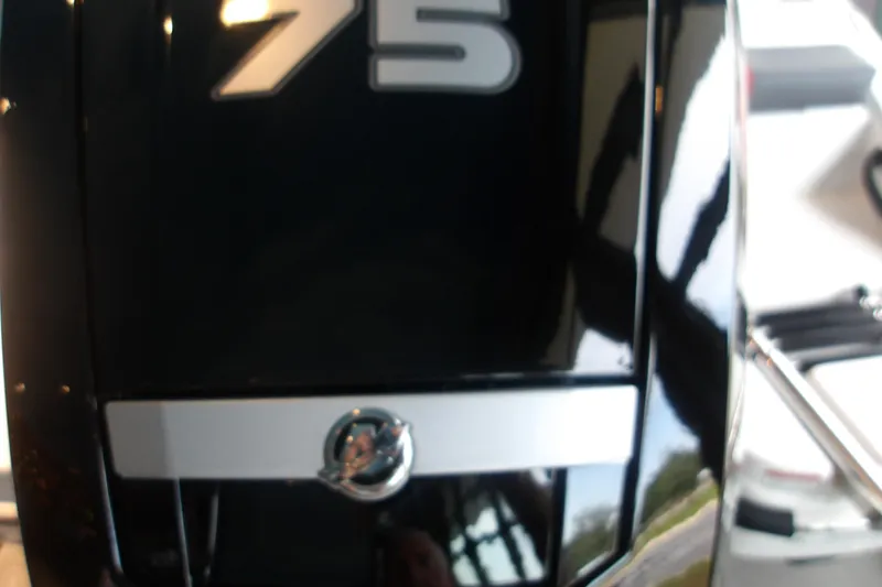 Slide: The Image of Close-up of 2026 Tahoe T16 boat engine with reflective surface and logo. - 4