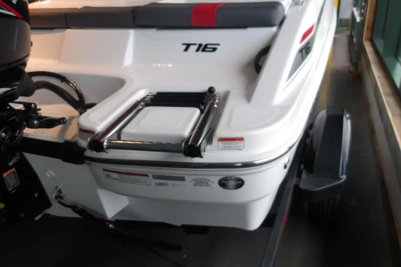 Slide: The Image of 2026 Tahoe T16 boat rear view with ladder and trailer. - 2