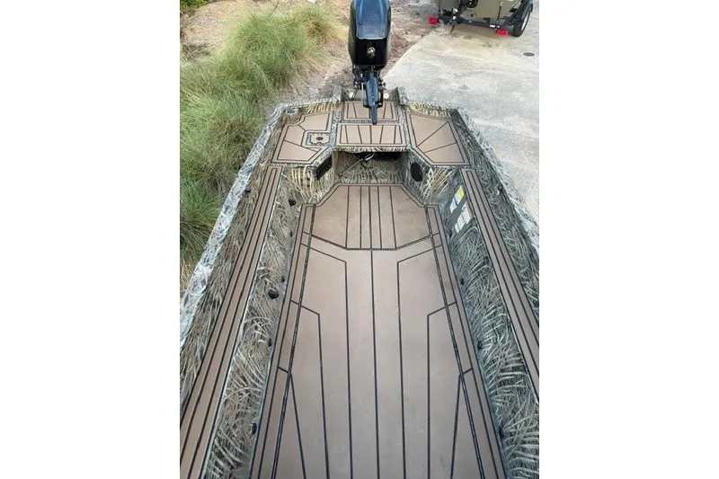 Slide: The Image of 2026 Tracker Grizzly 1650 T Prairie Wings Edition boat interior with camouflage design. - 11