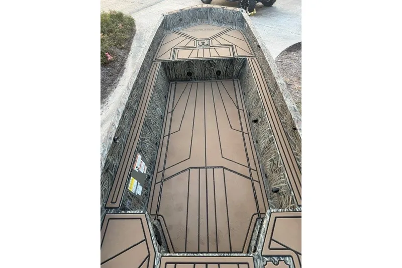 Slide: The Image of 2026 Tracker Grizzly 1650 T Prairie Wings Edition boat interior with camo design. - 5